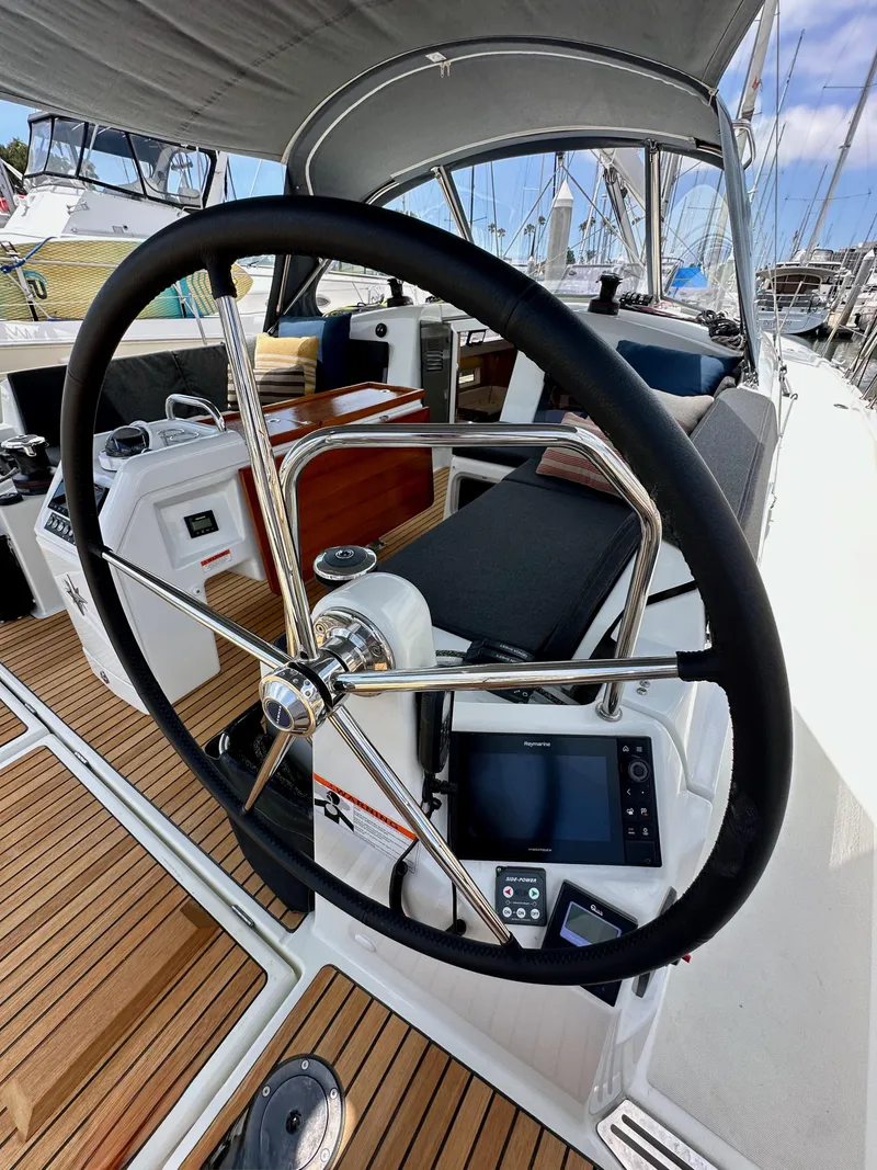 Slide: The Image of Steering wheel of 2021 Jeanneau Sun Odyssey 440 sailboat with teak deck and navigation equipment. - 25