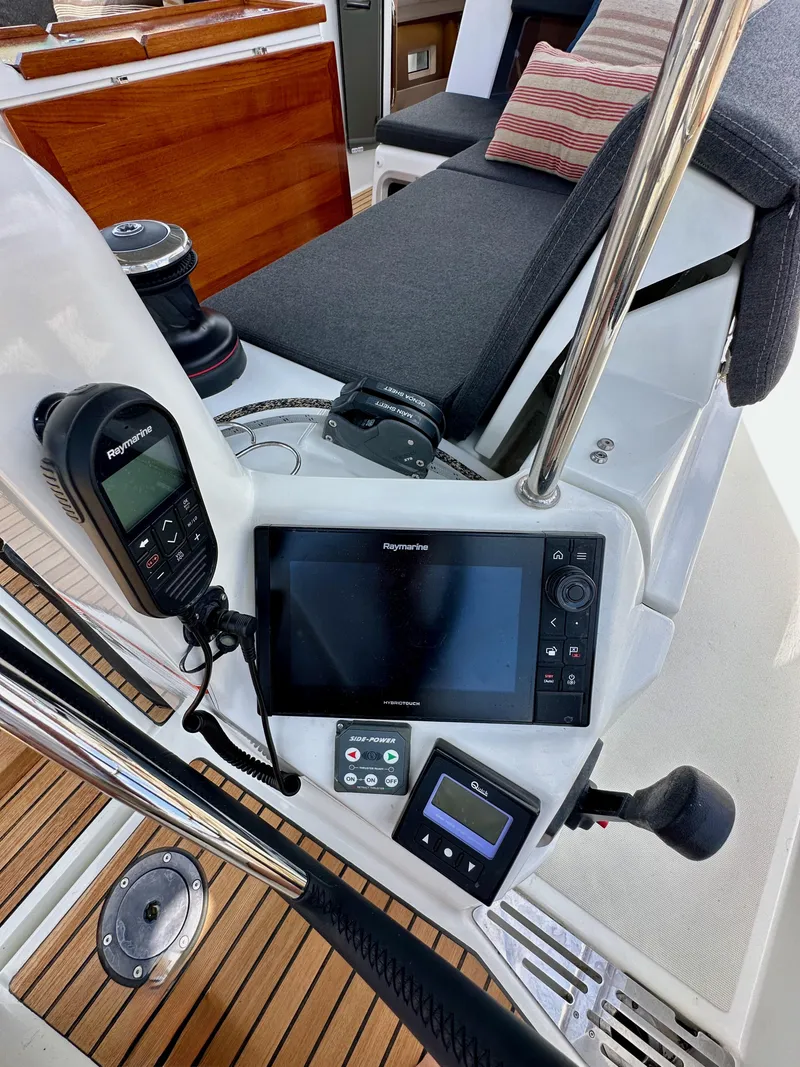 Slide: The Image of Cockpit of 2021 Jeanneau Sun Odyssey 440 with navigation equipment and seating. - 26