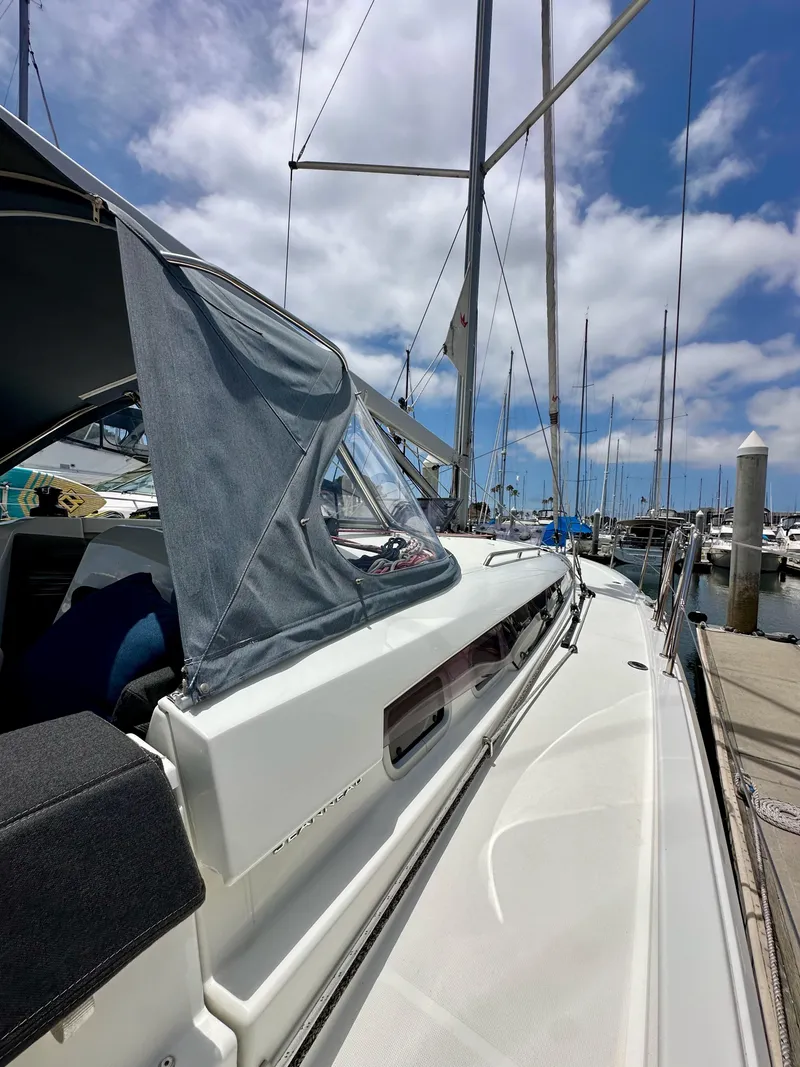 Slide: The Image of Jeanneau Sun Odyssey 440 sailboat docked at marina, 2021 model, under clear blue sky. - 31