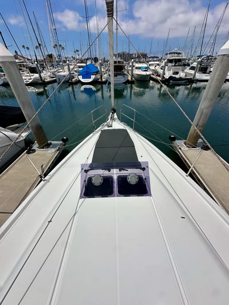 Slide: The Image of Jeanneau Sun Odyssey 440 sailboat docked at marina, 2021 model, clear sky, calm water. - 33