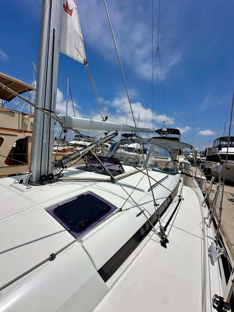 Slide: The Image of Jeanneau Sun Odyssey 440 sailboat docked, 2021 model, under clear blue sky. - 40