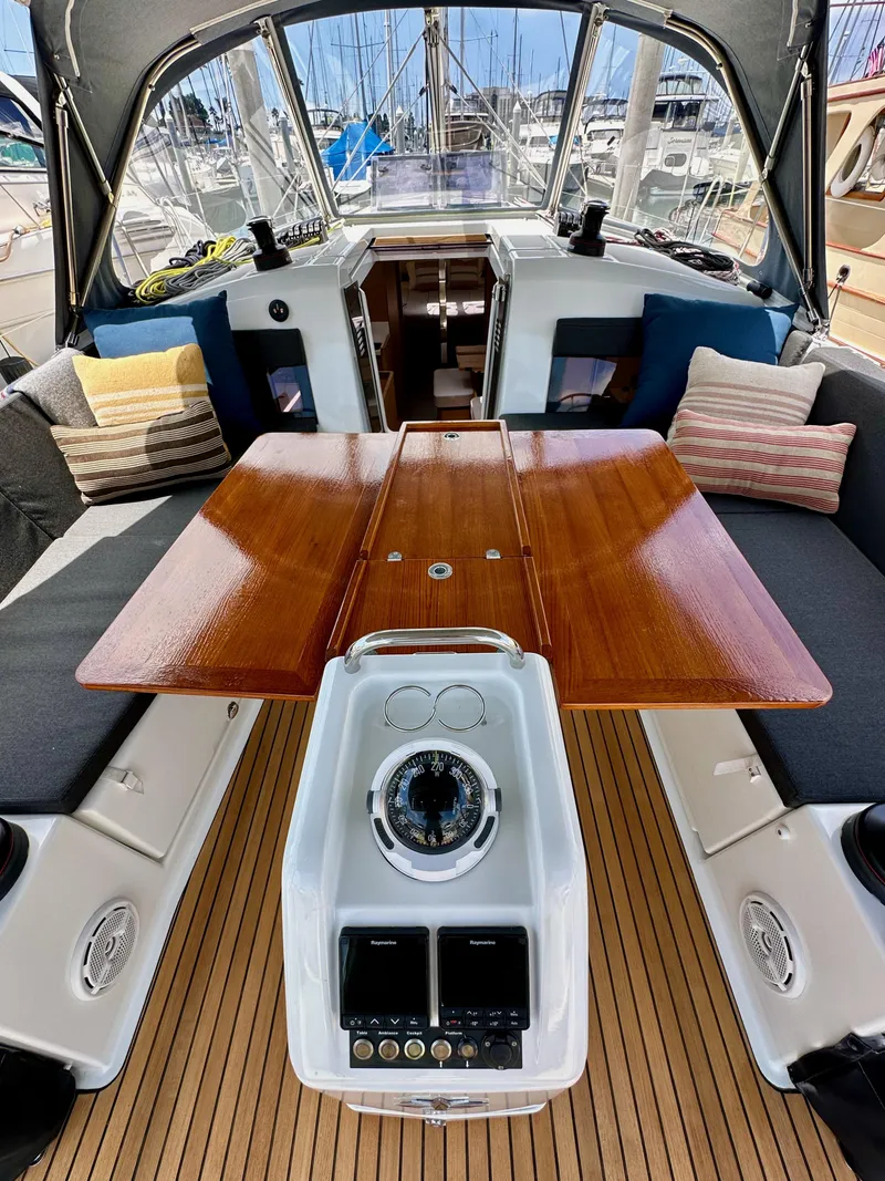Slide: The Image of Jeanneau Sun Odyssey 440 cockpit with wooden table and navigation instruments, 2021 model. - 45
