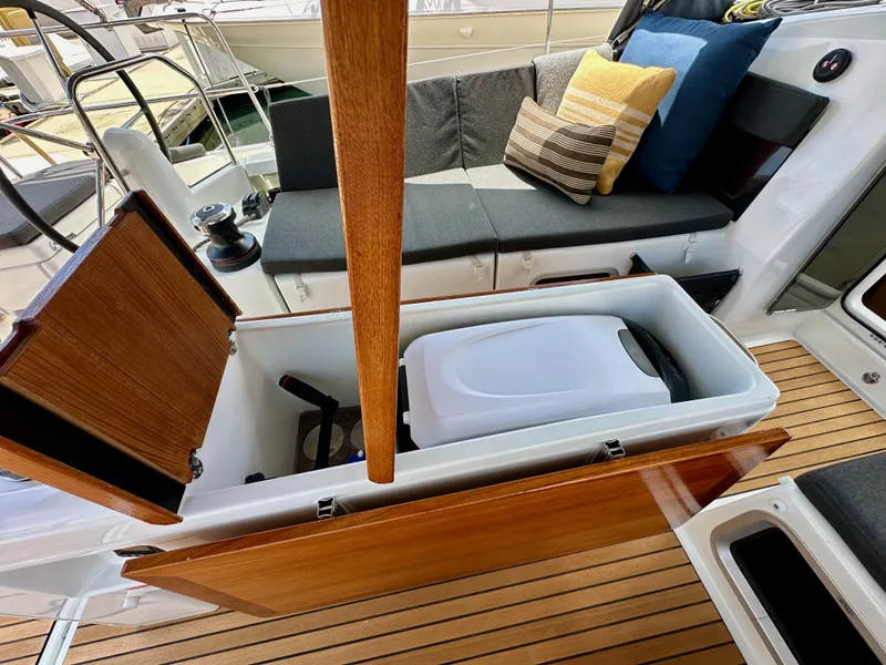 Slide: The Image of Jeanneau Sun Odyssey 440 cockpit with storage compartment, cushions, and wooden flooring, 2021 model. - 46