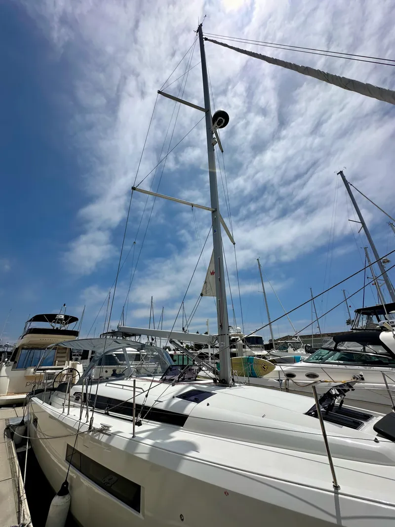 Slide: The Image of Jeanneau Sun Odyssey 440 sailboat docked, 2021 model, under a partly cloudy sky. - 8