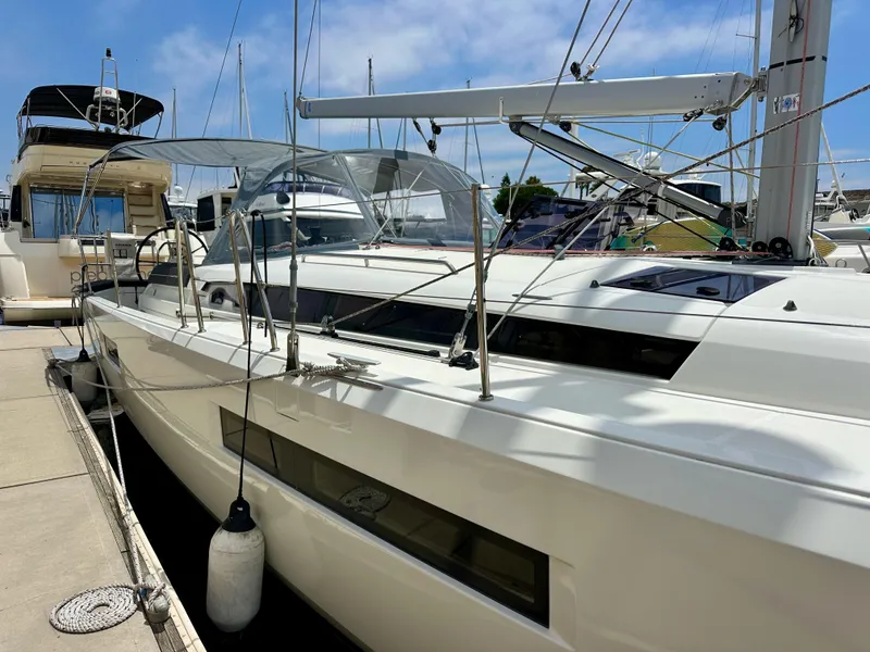 Slide: The Image of Jeanneau Sun Odyssey 440 sailboat, 2021 model, docked at marina under clear sky. - 9
