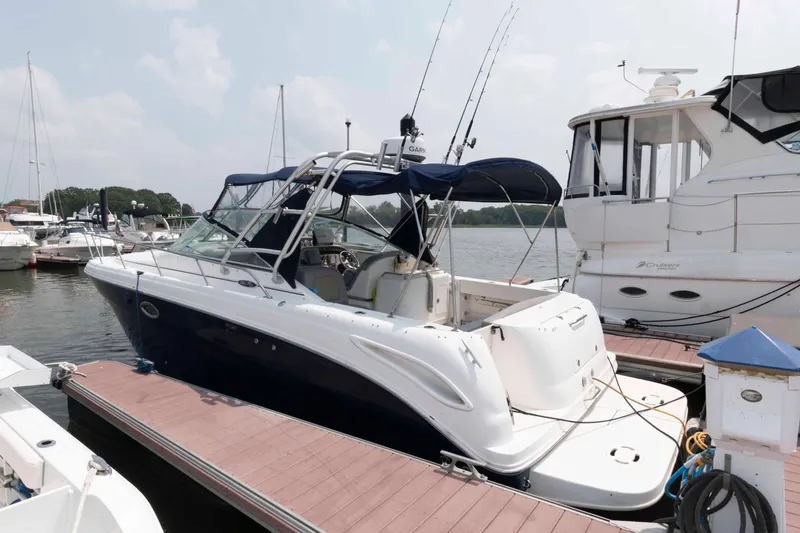 The Image of 2005 Sea Ray 290 Amberjack docked at marina, featuring sleek design and fishing equipment. - 0