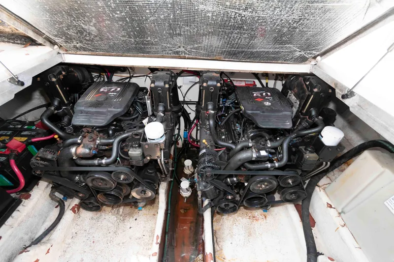 Slide: The Image of Engine compartment of a 2005 Sea Ray 290 Amberjack boat, featuring dual engines. - 12