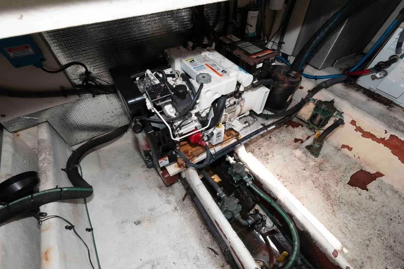Slide: The Image of Engine compartment of a 2005 Sea Ray 290 Amberjack boat, showing mechanical components. - 13
