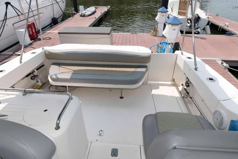Slide: The Image of 2005 Sea Ray 290 Amberjack boat interior with seating, docked at marina. - 2
