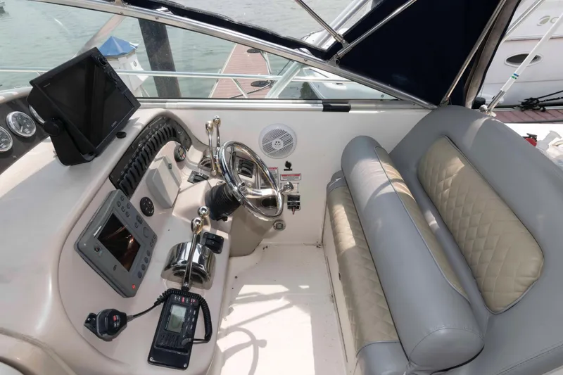 Slide: The Image of 2005 Sea Ray 290 Amberjack helm with steering wheel, controls, and navigation equipment. - 3