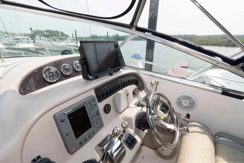 Slide: The Image of 2005 Sea Ray 290 Amberjack helm with navigation equipment and steering wheel. - 5