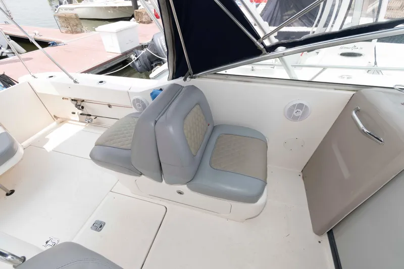 Slide: The Image of 2005 Sea Ray 290 Amberjack boat interior with cushioned seating and canopy. - 7