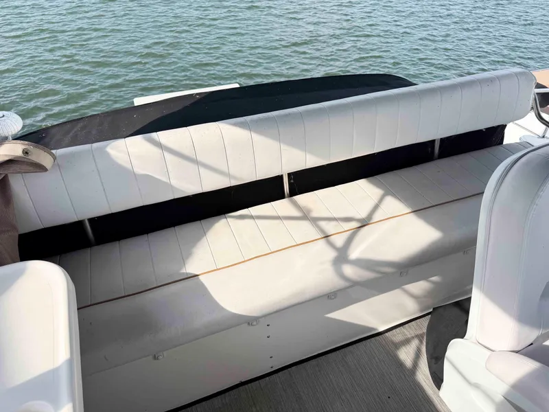 Slide: The Image of White seating on 1998 Sea Ray 440 Express Bridge boat, overlooking water. - 12