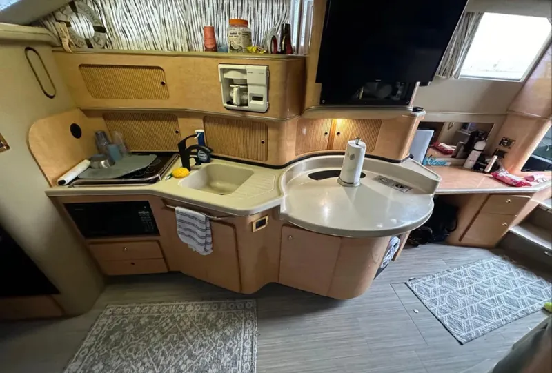 Slide: The Image of Interior of 1998 Sea Ray 440 Express Bridge yacht kitchen with modern amenities. - 18