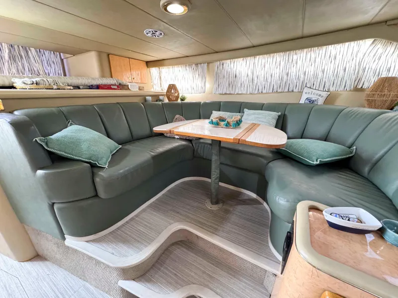 Slide: The Image of Luxurious interior of 1998 Sea Ray 440 Express Bridge with plush seating and elegant decor. - 20