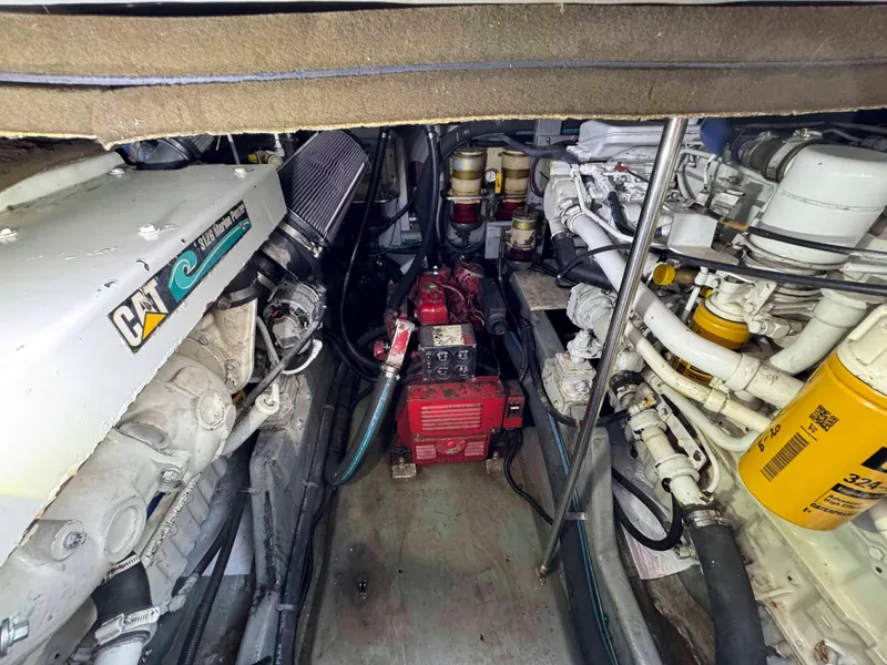Slide: The Image of Engine room of a 1998 Sea Ray 440 Express Bridge with visible machinery and components. - 27