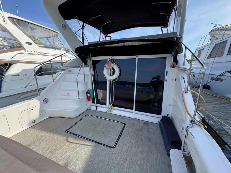 Slide: The Image of 1998 Sea Ray 440 Express Bridge yacht interior with stairs and sliding glass doors. - 3