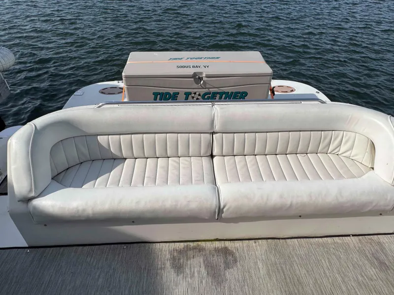 Slide: The Image of White leather seating on 1998 Sea Ray 440 Express Bridge yacht, with water backdrop. - 5