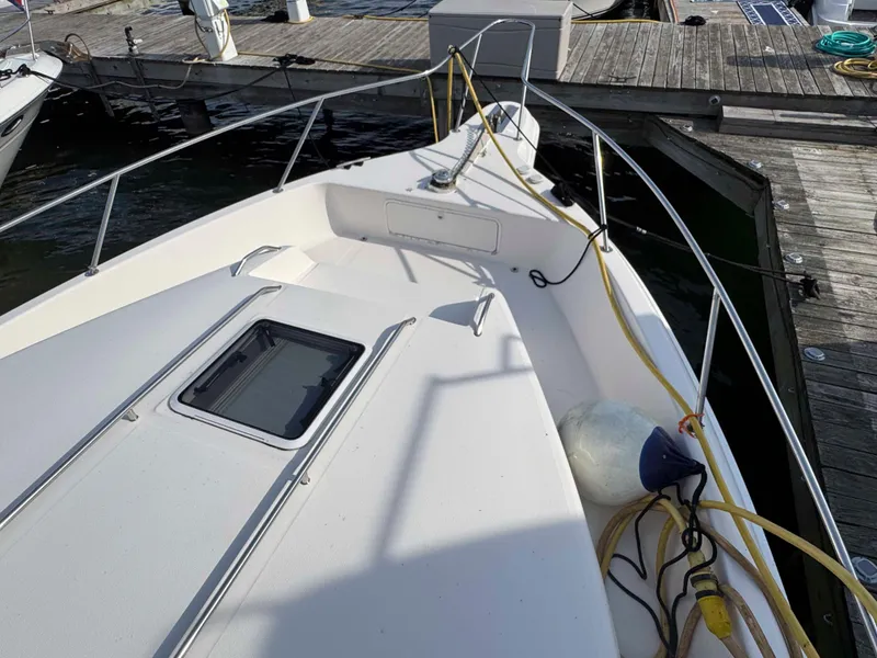 Slide: The Image of 1998 Sea Ray 440 Express Bridge docked, showing deck and railing details. - 6