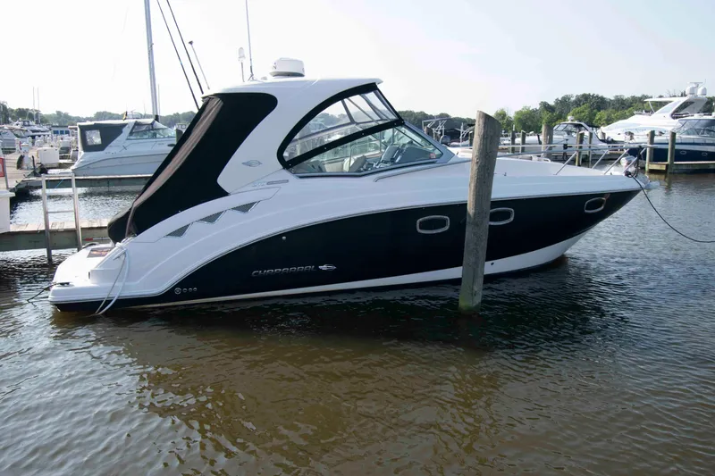 Slide: The Image of 2014 Chaparral 310 Signature boat docked in marina, side view. - 2