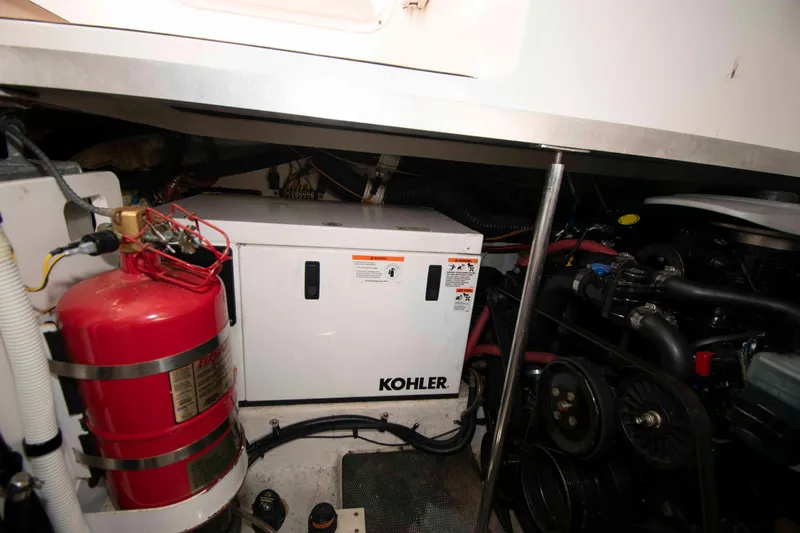 Slide: The Image of Engine room of 2014 Chaparral 310 Signature with Kohler generator and fire extinguisher. - 26