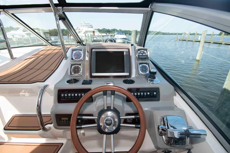 Slide: The Image of Cockpit view of 2014 Chaparral 310 Signature boat with steering wheel and control panel. - 9