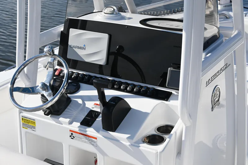 Slide: The Image of 2021 Sea Hunt Ultra 219 boat dashboard with Garmin navigation system and steering wheel. - 15