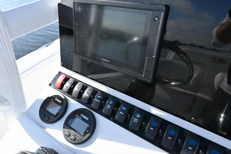 Slide: The Image of Control panel of 2021 Sea Hunt Ultra 219 boat with Garmin display and Yamaha gauges. - 17