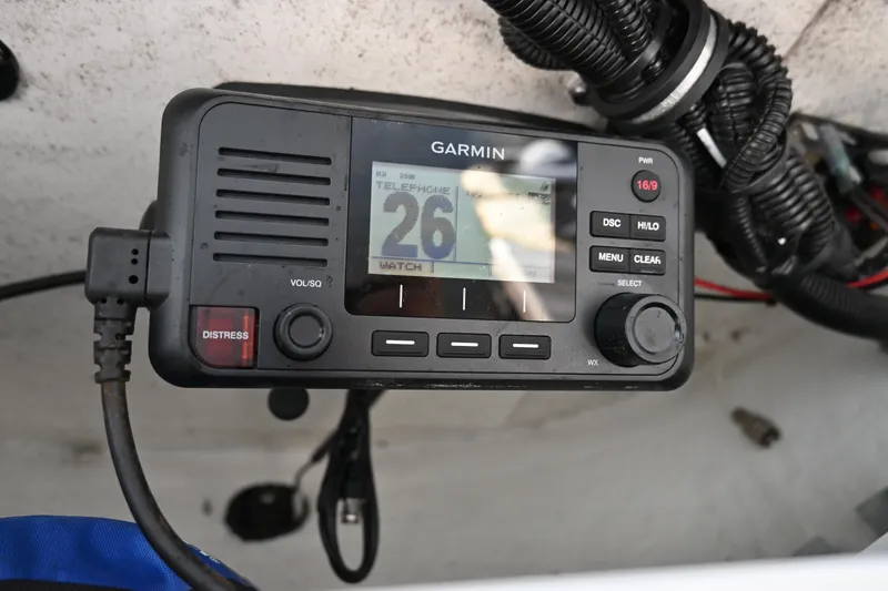 Slide: The Image of Garmin marine radio on 2021 Sea Hunt Ultra 219 boat, displaying channel 26. - 20