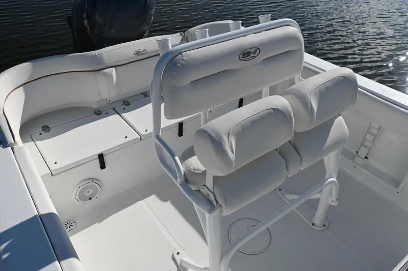 Slide: The Image of 2021 Sea Hunt Ultra 219 boat interior with cushioned seating and storage compartments. - 21