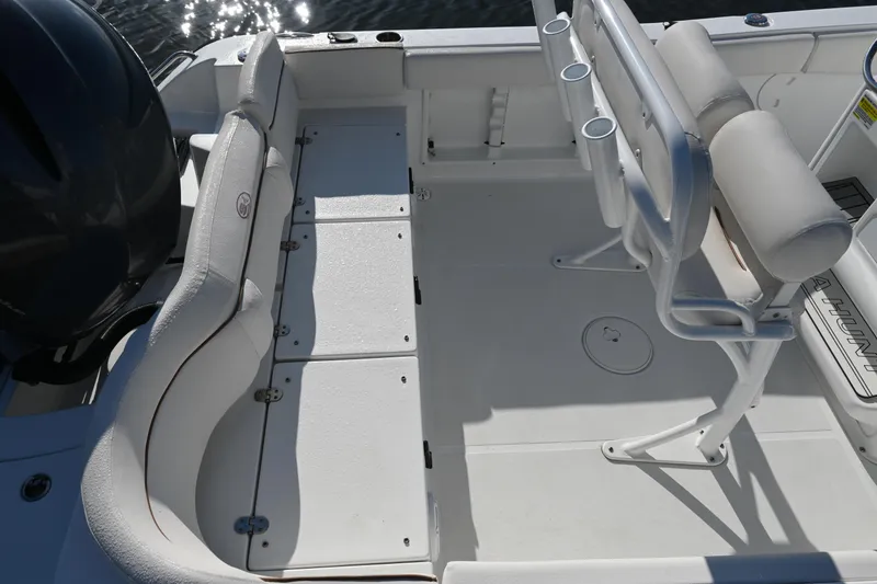 Slide: The Image of 2021 Sea Hunt Ultra 219 boat interior with seating and rod holders. - 22