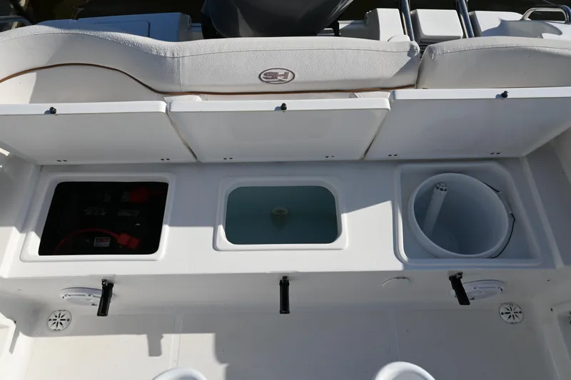 Slide: The Image of 2021 Sea Hunt Ultra 219 boat storage compartments and seating area. - 23