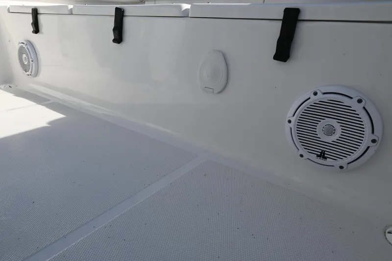 Slide: The Image of 2021 Sea Hunt Ultra 219 boat interior with speakers and storage compartments. - 25
