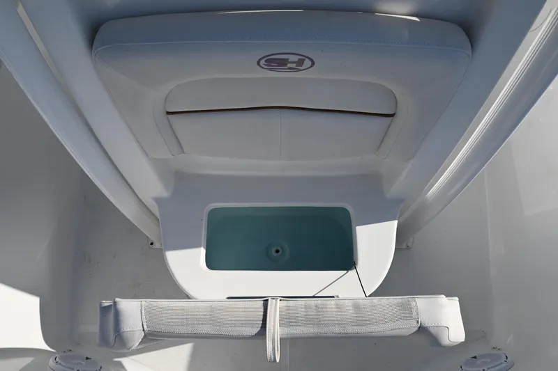 Slide: The Image of 2021 Sea Hunt Ultra 219 boat interior with storage compartment and seating area. - 31