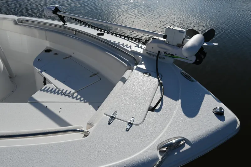 Slide: The Image of 2021 Sea Hunt Ultra 219 boat bow with trolling motor on calm water. - 32