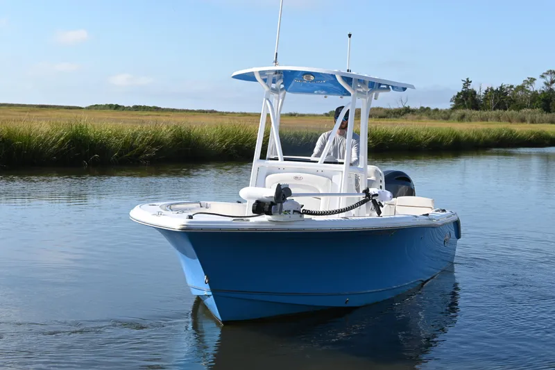 Slide: The Image of 2021 Sea Hunt Ultra 219 boat cruising on a calm waterway. - 4