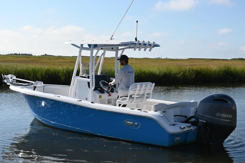 Slide: The Image of 2021 Sea Hunt Ultra 219 boat with Yamaha engine on a calm waterway. - 7