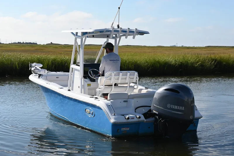 Slide: The Image of 2021 Sea Hunt Ultra 219 boat with Yamaha engine on calm water. - 8