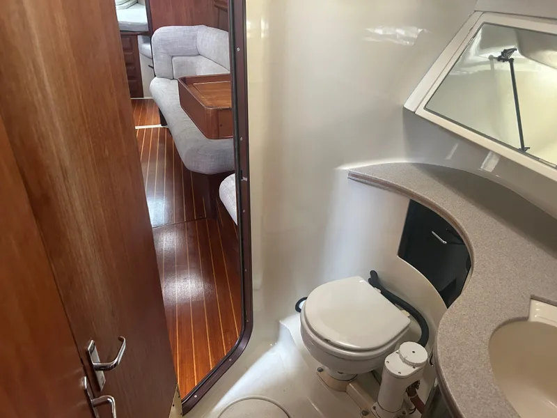 Slide: The Image of Interior of 1994 Hunter Legend 40.5 yacht showing bathroom and seating area. - 11