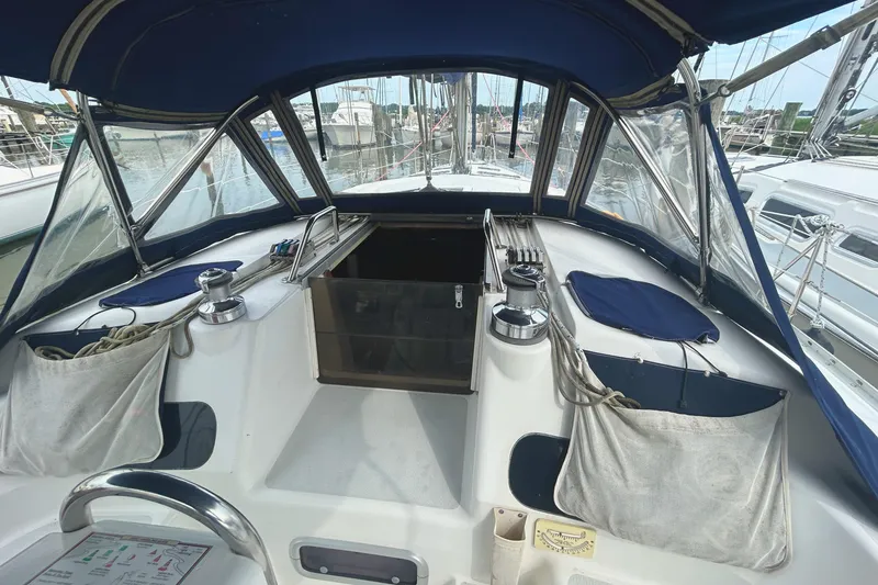 Slide: The Image of Cockpit of 1994 Hunter Legend 40.5 sailboat with blue canopy and winches. - 18