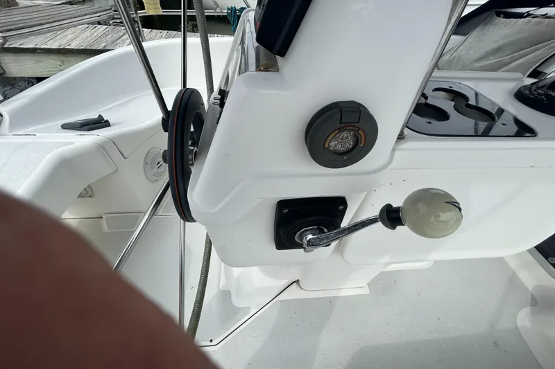 Slide: The Image of Cockpit controls of a 1994 Hunter Legend 40.5 sailboat, featuring steering and throttle. - 19