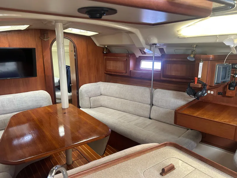 Slide: The Image of Interior of 1994 Hunter Legend 40.5 yacht with wood finish and cozy seating area. - 2