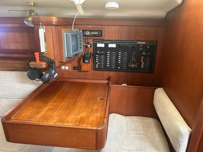 Slide: The Image of Navigation station of a 1994 Hunter Legend 40.5 sailboat with control panel and equipment. - 22