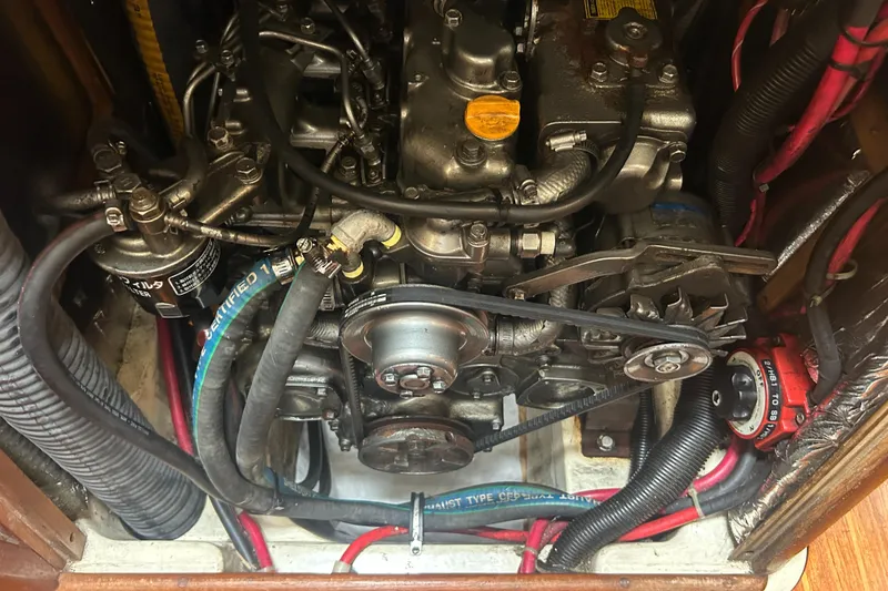 Slide: The Image of Engine compartment of a 1994 Hunter Legend 40.5 sailboat, showing belts and hoses. - 25