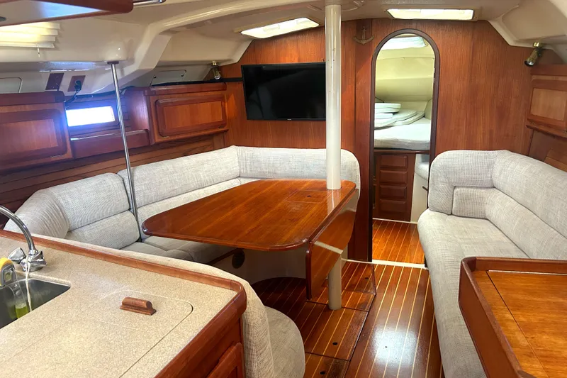 Slide: The Image of Interior of 1994 Hunter Legend 40.5 sailboat with wood finish and cozy seating area. - 3
