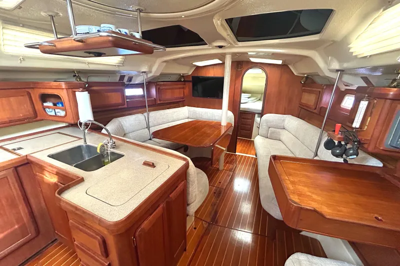 Slide: The Image of Interior of 1994 Hunter Legend 40.5 yacht with wood finish and cozy seating area. - 4