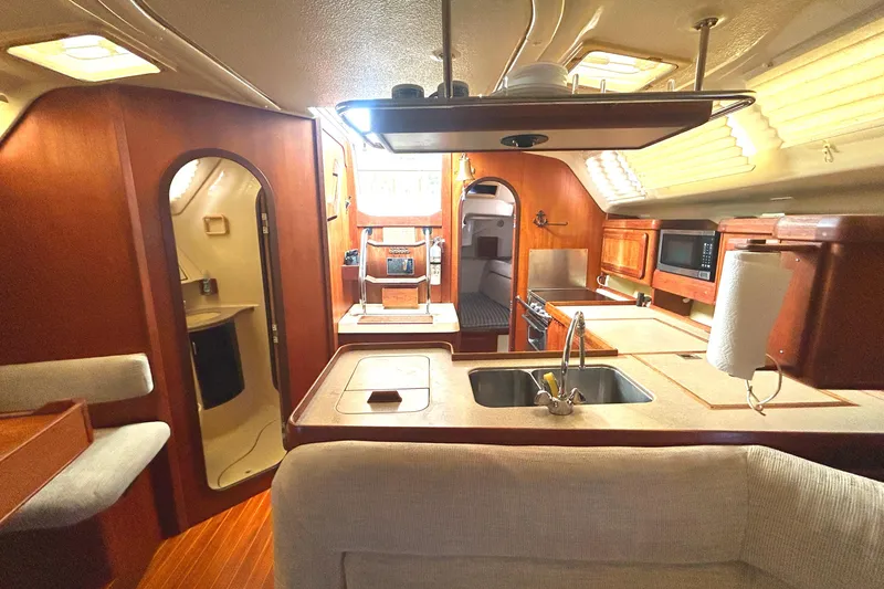 Slide: The Image of Interior of 1994 Hunter Legend 40.5 yacht with kitchen and seating area. - 5