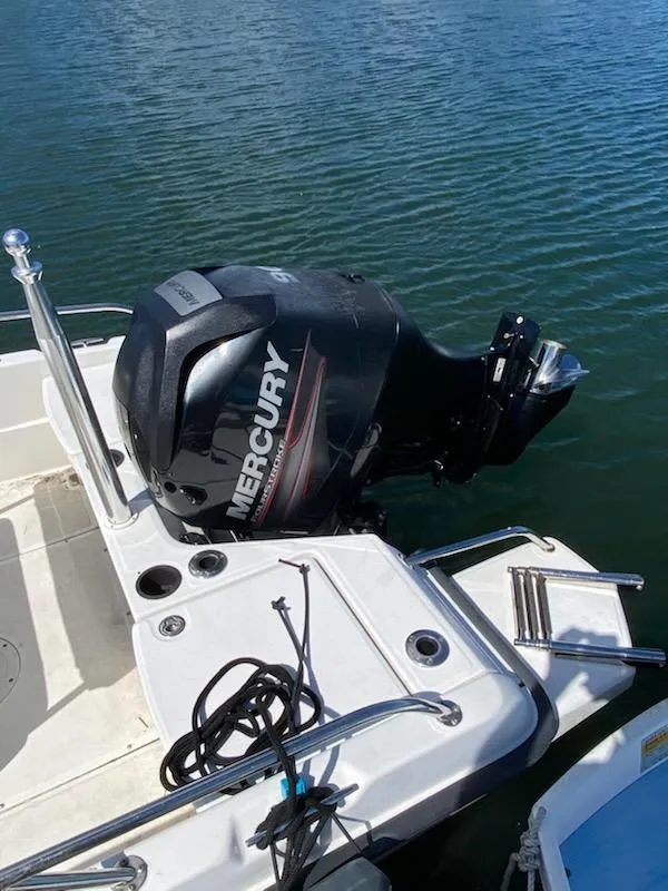 Slide: The Image of 2014 Boston Whaler 170 Dauntless with Mercury outboard engine on water. - 2