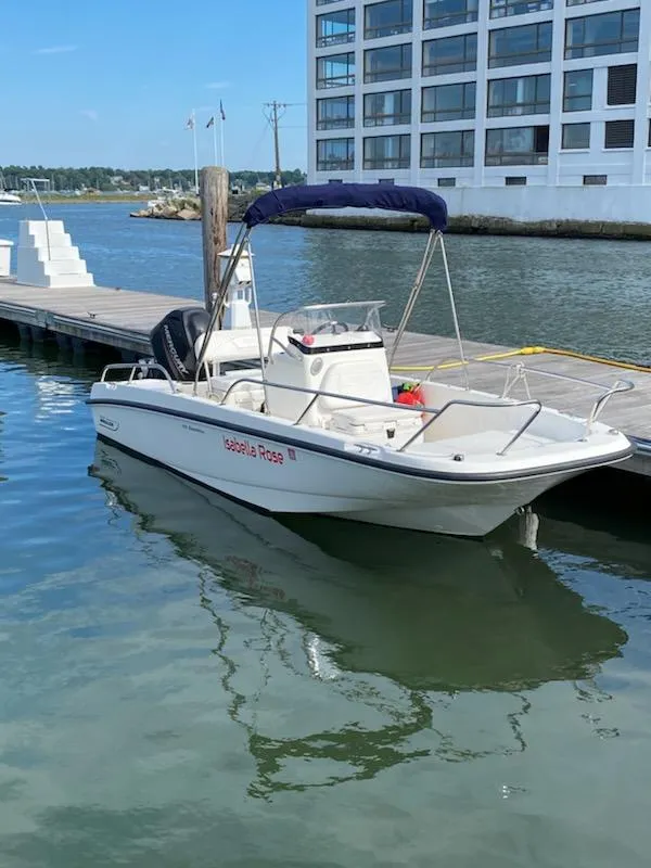 Slide: The Image of 2014 Boston Whaler 170 Dauntless boat docked by waterfront building. - 4