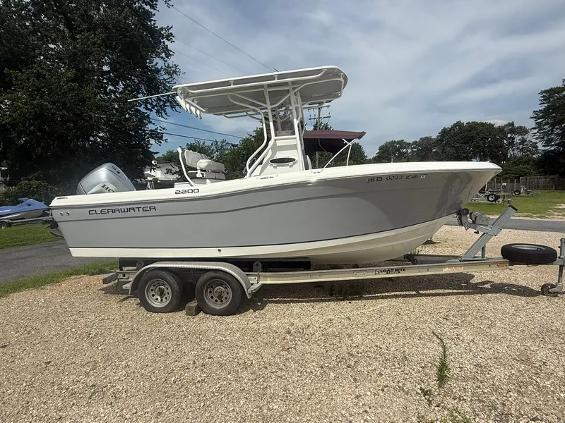 The Image of 2018 Clearwater 2200CC boat on trailer, parked outdoors on gravel. - 1